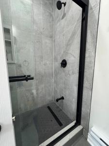 a shower stall with a glass door with a shower at Home away from home! in Pickering