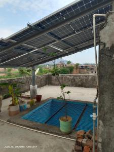 a swimming pool with a solarium on top of a house at Shri chitrakoot homestay in Chitrakoot