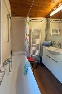 a bathroom with a large tub and a sink at Chalet Bim Chilchli in Mürren +37 photos