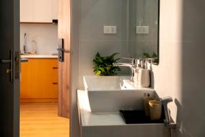 a bathroom with a white sink in a kitchen at Lumia Hotel Vinh Yen in Vĩnh Phúc +27 photos