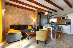 a living room with a couch and a table at Corden Village in Łeba
