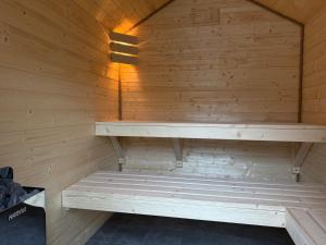 a sauna with a bench in a wooden wall at Wilcza Osada Wellness Resort in Wilcza +15 photos