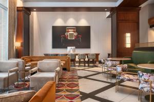 a lobby with a painting of a car on the wall at Hampton Inn Chicago McCormick Place in Chicago