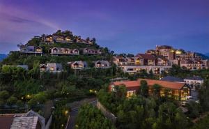 a group of houses on a hill at night at Conrad Hangzhou Tonglu in Yinzhu