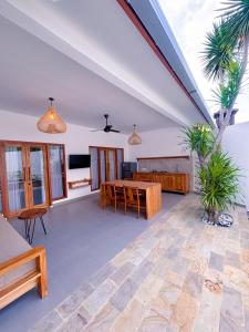 a living room with a table and a couch at Ajolie Villa in Gili Islands