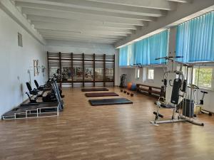 a gym with several treadmills and machines in a room at Hotel Traian Eforie Nord in Eforie Nord