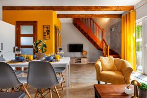 a living room with a white table and chairs at Corden Village in Łeba
