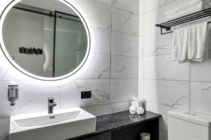 a white bathroom with a sink and a mirror at The Viv Hotel Wellington in Wellington +63 photos