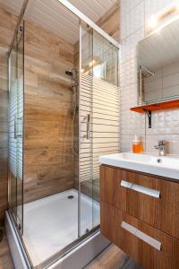 a bathroom with a shower and a sink at Corden Village in Łeba +36 photos