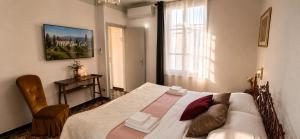 a bedroom with a bed and a table and a window at Lavanda Cozy Apartment near Lake Como and Lugano in Lanzo dʼIntelvi