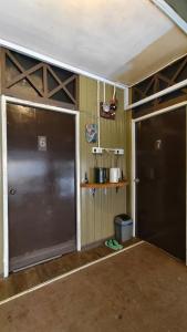 an empty garage with two doors in a room at AKI Backpackers in Ranau