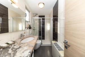 a bathroom with a sink and a toilet at Villa Kovac in Zadar +31 photos