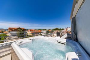 a hot tub on the balcony of a building at Villa Kovac in Zadar