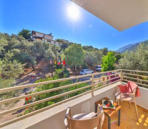a balcony with chairs and a table with a view at Kaşhan Otel in Kaş