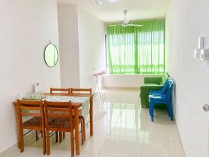 a dining room with a table and chairs at JAA Homes 1-8 Pax Family Stay Jalan UMS KK in Kota Kinabalu