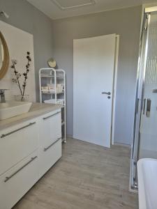 a bathroom with a sink and a white door at Justine's house in Alvignac in Alvignac +41 photos