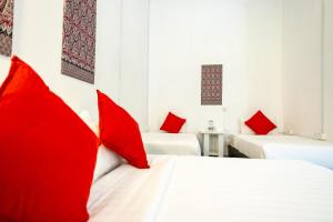 a room with two beds with red pillows at Coral Reef Holidays in Tioman Island