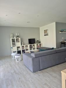 a living room with a couch and a television at Justine's house in Alvignac in Alvignac