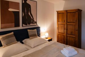 a bedroom with a bed and a painting on the wall at Villa ZENORIA in Zuberec