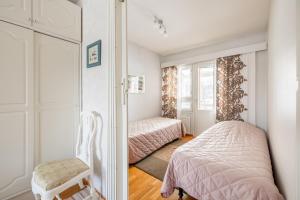 a small bedroom with a bed and a mirror at Pyynpesä ! in Rovaniemi