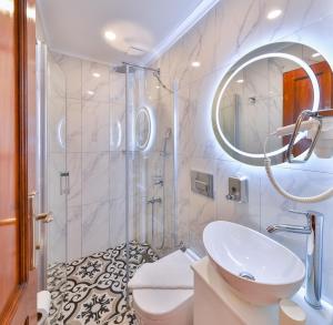 a white bathroom with a sink and a shower at Kaşhan Otel in Kaş +99 photos