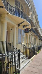 a building with stairs and a balcony on it at Sigma Plus Regency Square Suites near Brighton Beach in Brighton & Hove
