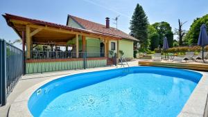 a swimming pool in front of a house at Villa Magic by Villas Guide in Jalžabet