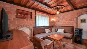 a living room with a couch and a table at Villa Magic by Villas Guide in Jalžabet