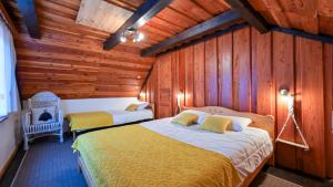 two beds in a room with wooden walls at Villa Magic by Villas Guide in Jalžabet +42 photos
