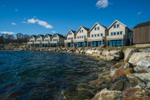 a row of houses on the shore of a body of water at Steam Pier Adventure Hotel in Tromsø