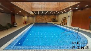 a large swimming pool in a building at Peace Hotel Beijing in Beijing