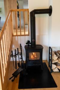 a wood stove in a room with a staircase at Villa ZENORIA in Zuberec