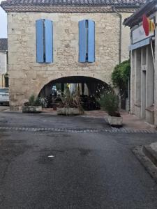 a stone building with blue shutters on it at La casa del camino in Montréal +7 photos