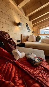 a bedroom with two beds in a log cabin at Wieslhütte in Gerlosberg