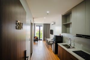 a kitchen with a counter and a dining room at Lumia Hotel Vinh Yen in Vĩnh Phúc