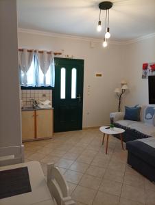 a living room with a couch and a table at Danai in Tsoukalades