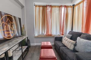 a living room with a couch and a television at Bright loft in Wheat Ridge in Wheat Ridge
