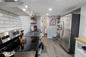 a kitchen with a stove and a refrigerator at Bright loft in Wheat Ridge in Wheat Ridge