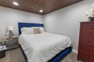 a bed with a blue headboard in a bedroom at Bright loft in Wheat Ridge in Wheat Ridge