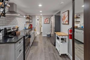 a kitchen with stainless steel appliances and wooden floors at Bright loft in Wheat Ridge in Wheat Ridge +17 photos