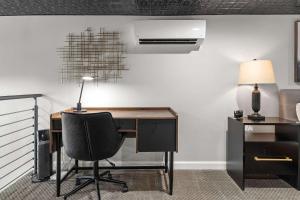 an office with a desk with a chair and a lamp at Industrial-Chic Loft-King Bed & Natural Light in Wheat Ridge +25 photos