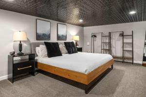 a bedroom with a bed in a room with shelves at Industrial-Chic Loft-King Bed & Natural Light in Wheat Ridge