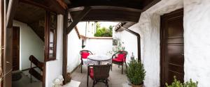 a patio with a table and chairs on a balcony at Pokoje Mars in Kazimierz Dolny