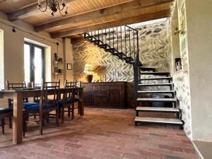 a dining room with a staircase and a table with chairs at Dusheti Retreat - Authentic Georgian Living in Dushetʼi