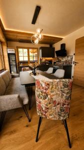 a kitchen with a bar with a couch and a table at Wieslhütte in Gerlosberg