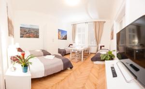 a hotel room with two beds and a desk at Fashion Loft in Prague