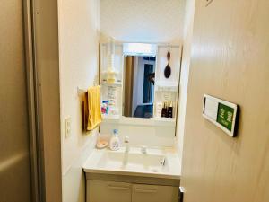 a bathroom with a sink and a mirror at 自遊人の宿 in Odawara +42 photos