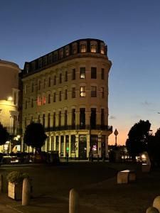 a tall building with lights on in a city at Imperial House "Serviced Apartments" in Margate