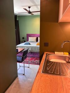 a bathroom with a sink and a bedroom with a bed at FinIQ Boutiq Studios in Foiníki