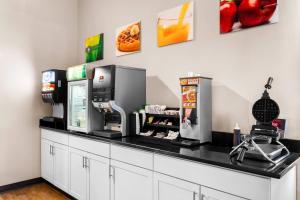 a coffee shop with a counter with a machine at Quality Inn & Suites Gorham White Mountains in Gorham